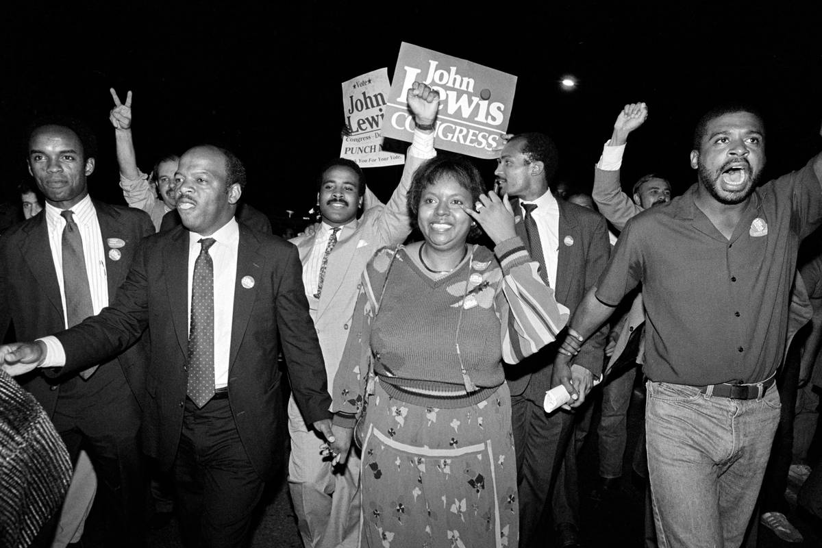 FILE - In this Tuesday night, Sept. 3, 1986, file photo, John Lewis, front left, and his wife, ...