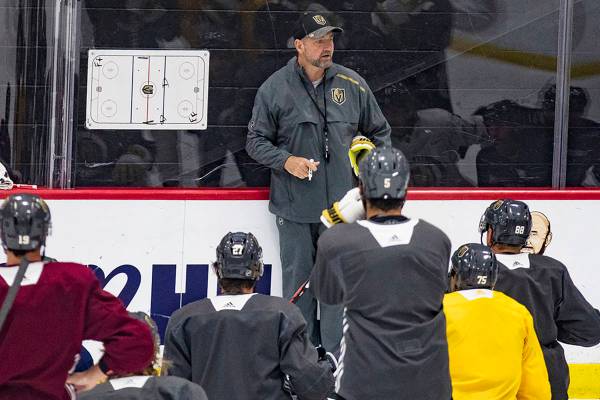 Golden Knights head coach Peter DeBoer addresses players during training camp practice at the C ...