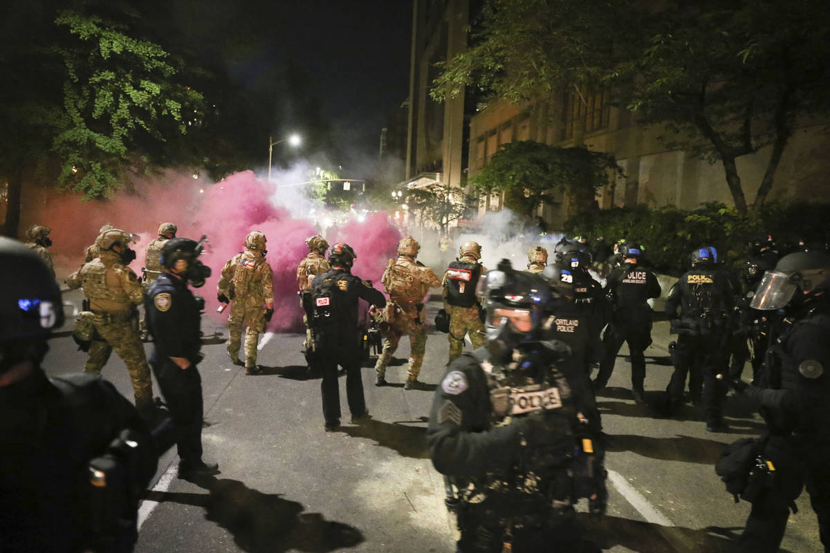 Police respond to protesters during a demonstration, Friday, July 17, 2020 in Portland, Ore. M ...