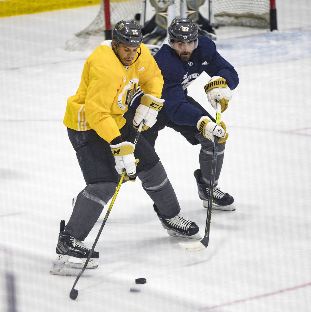 Golden Knights' Ryan Reaves (75) pushes past Alex Tuch (89) during training camp practice at th ...