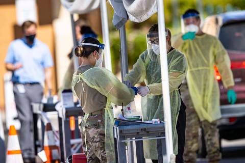 Members of the National Guard assist the UNLV School of Medicine with administering COVID-19 te ...