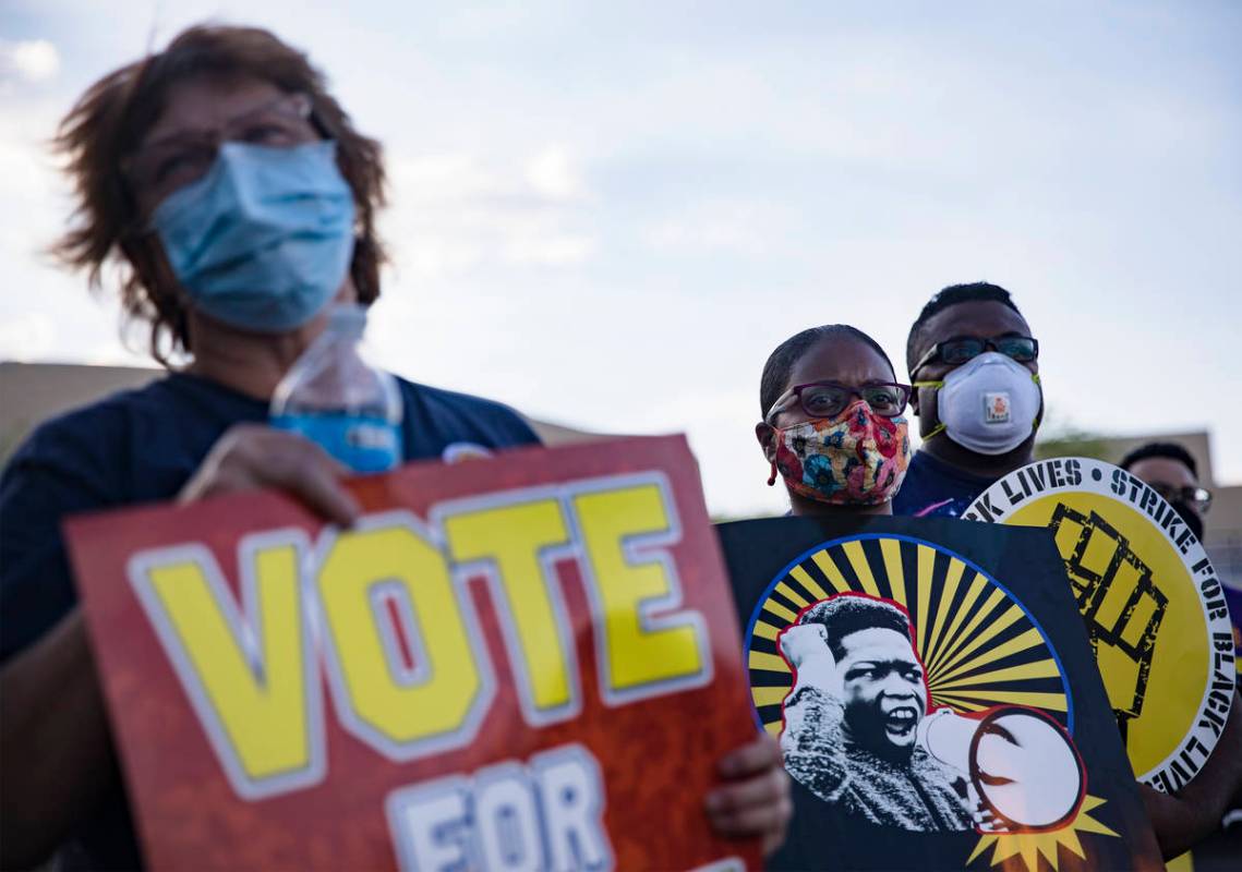 Linda Overbey, from left, Rabea Johnson and her husband Lonny Johnson listen during a rally in ...