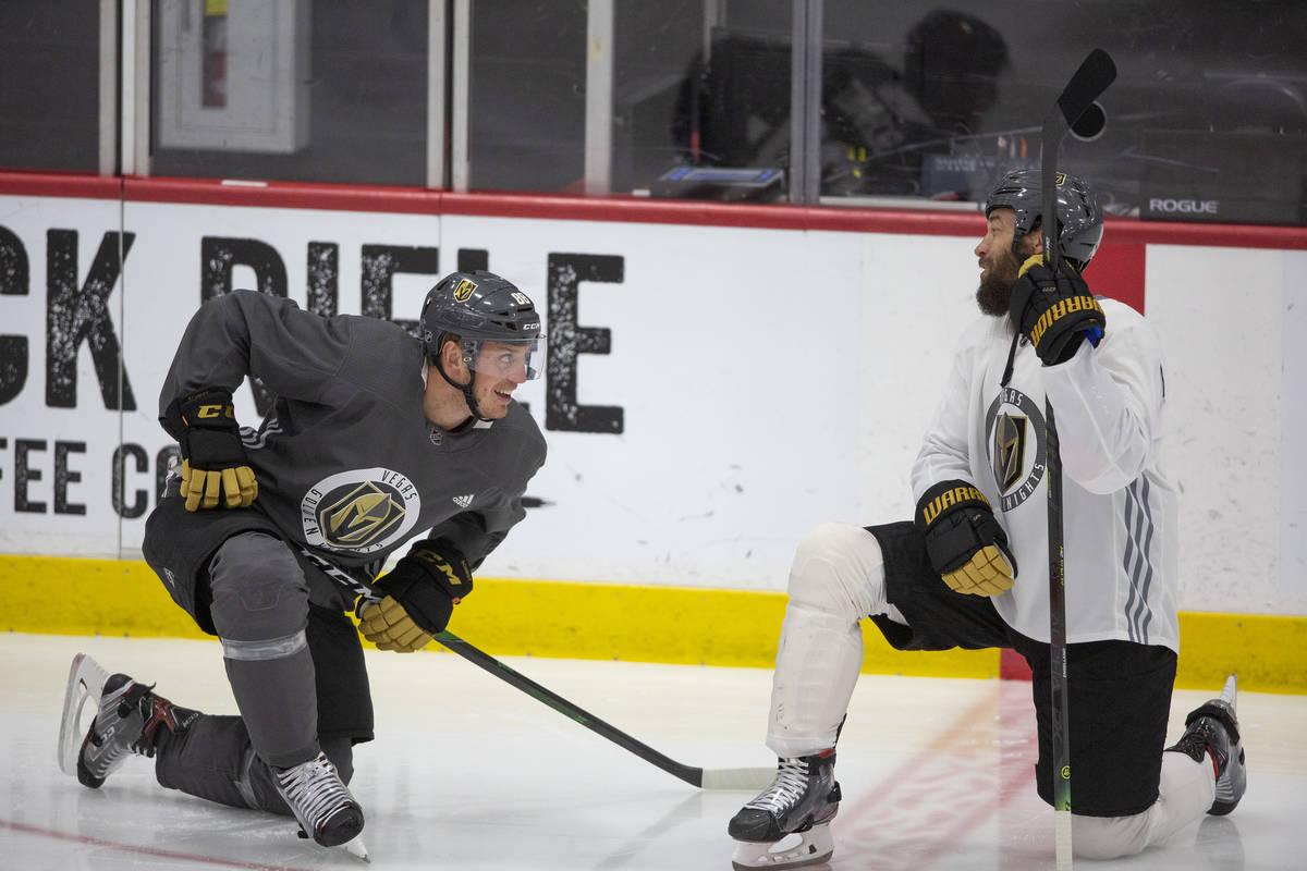 Golden Knights' defenseman Nate Schmidt (88) stretches with defenseman Deryk Engelland (5) duri ...