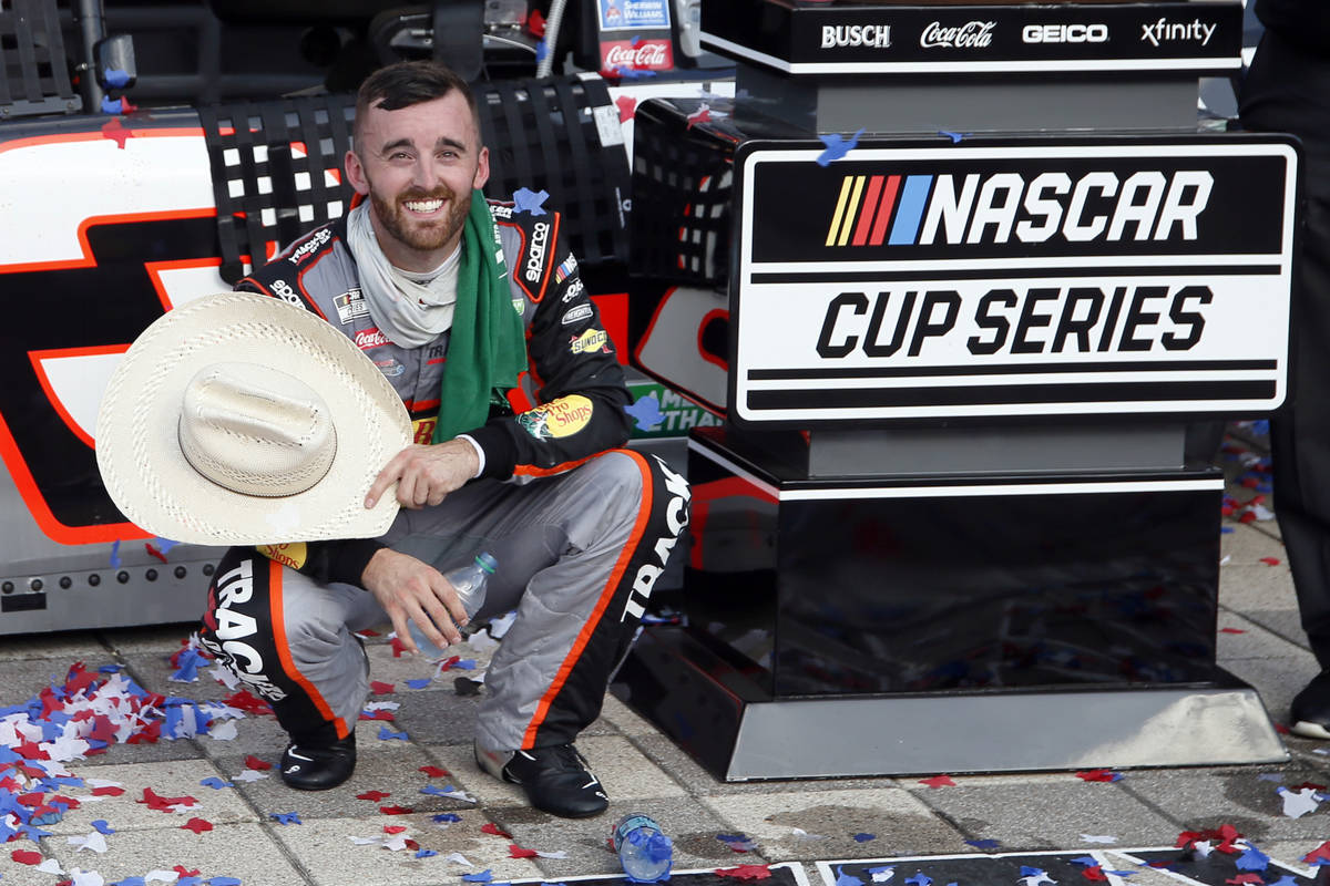 Austin Dillon smiles as he takes a knee in Victory Lane to catch his breath after winning a NAS ...