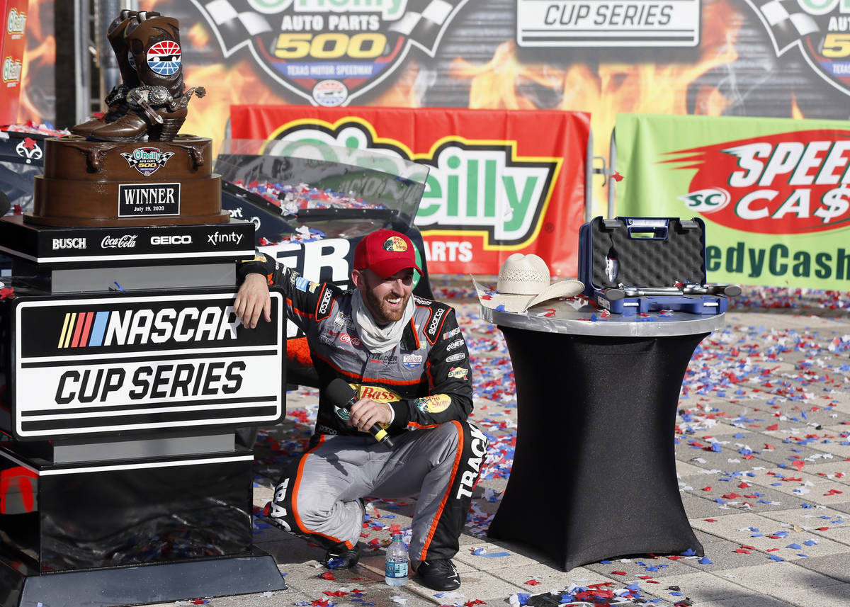 Austin Dillon smiles as he takes a knee in Victory Lane to catch his breath after winning a NAS ...