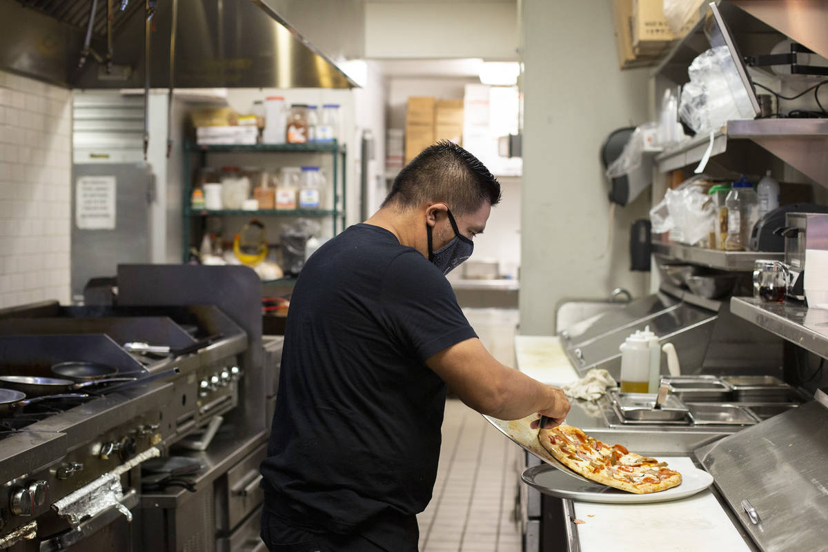 Chef Armando Pescuul plates a meat lovers pizza at The Blind Pig on Monday, July 20, 2020, in L ...