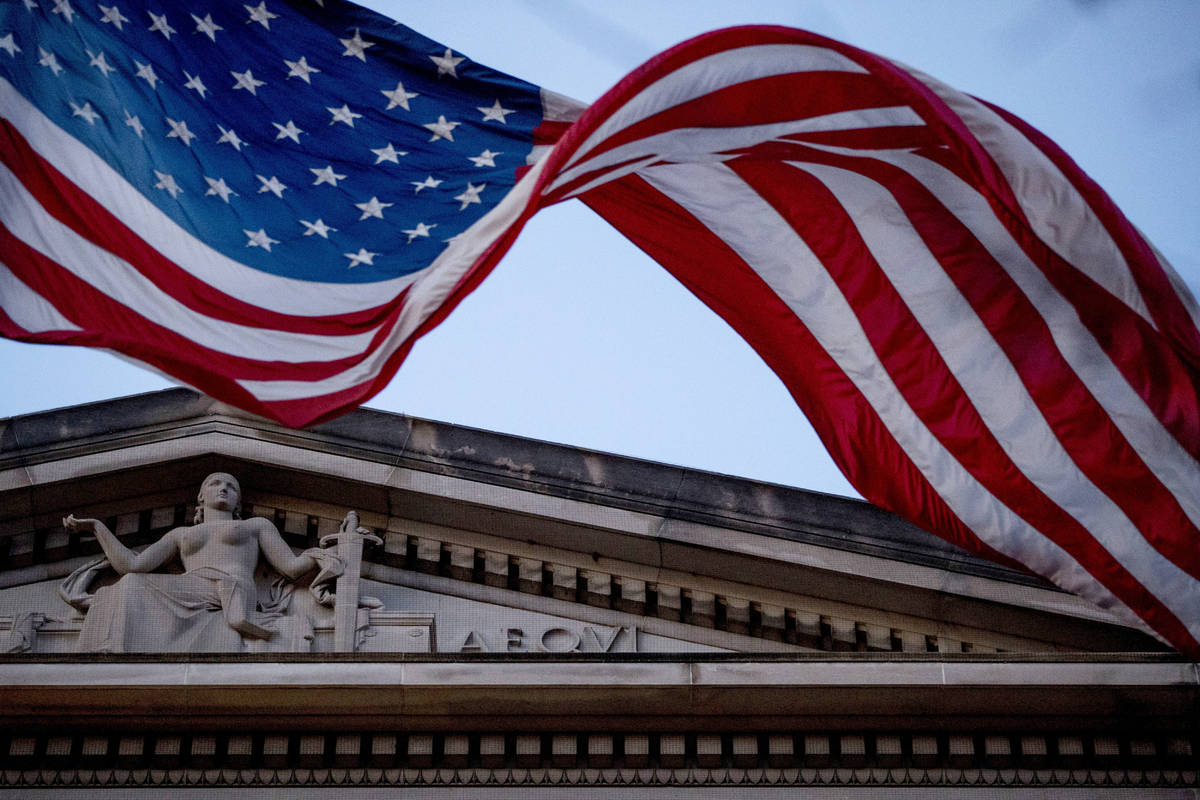 In a March 22, 2019 file photo, an American flag flies outside the Department of Justice in Was ...
