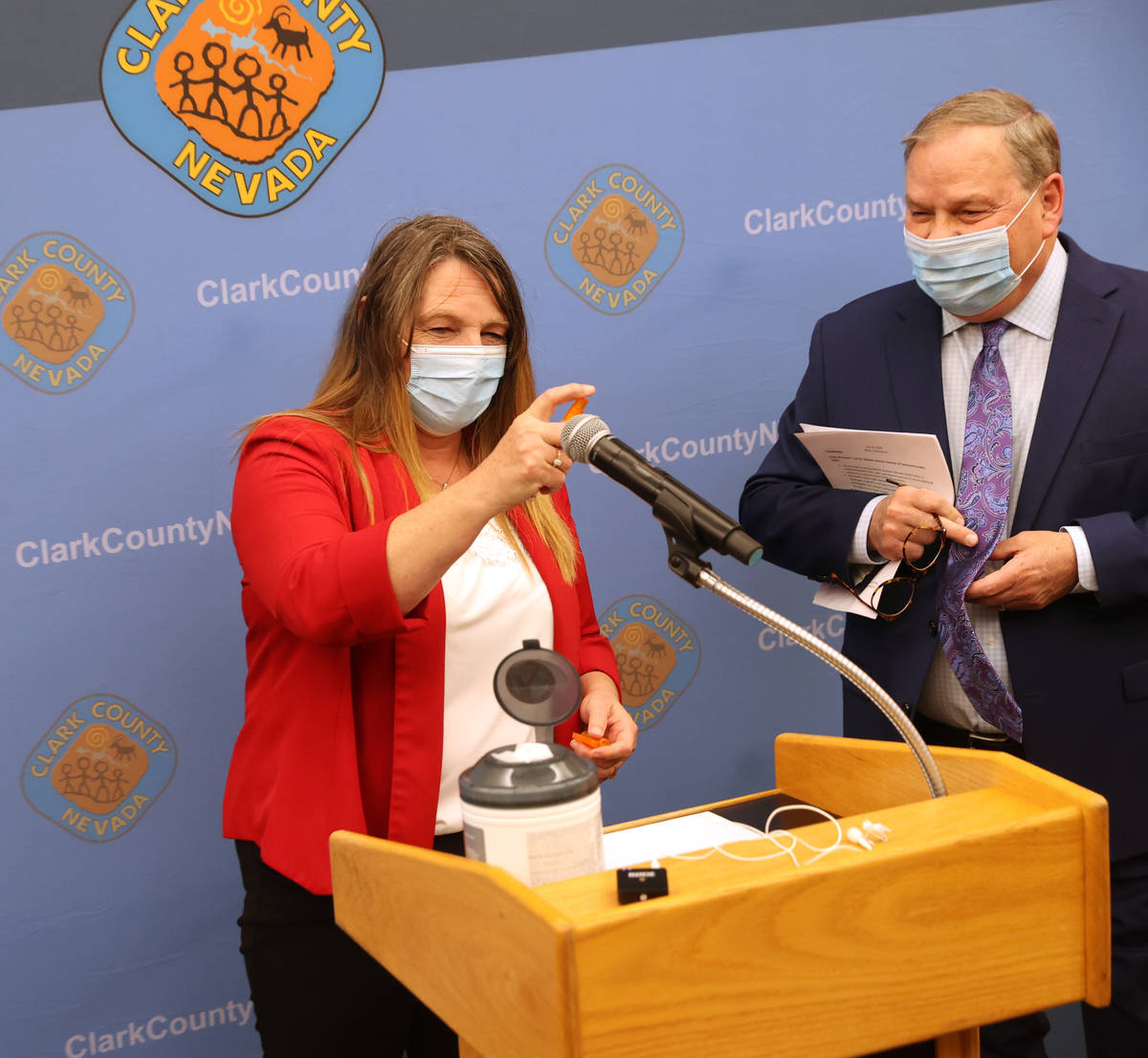 Clark County Commission Chairman Marilyn Kirkpatrick sanitizes the microphone as she and Dr. Mi ...