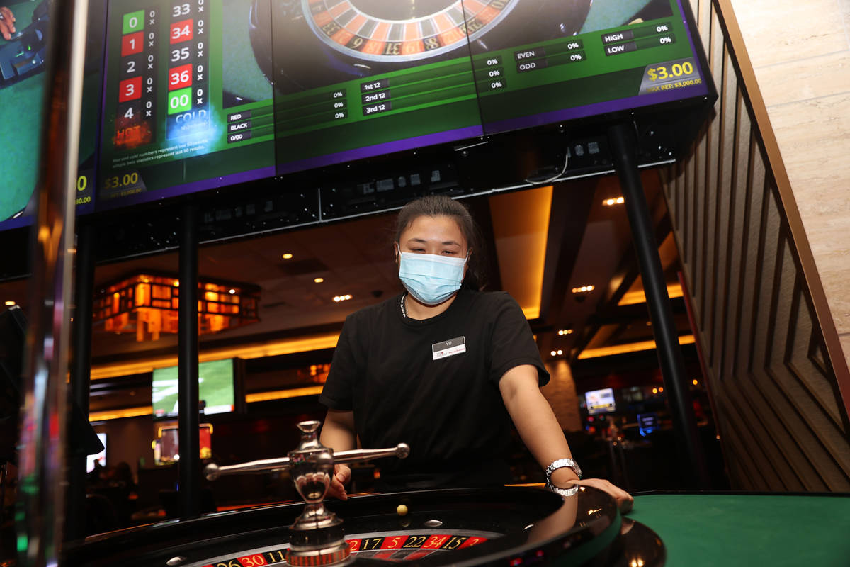 Table game dealer Xiumei Yu practices her throw on a roulette wheel at Palace Station Casino i ...