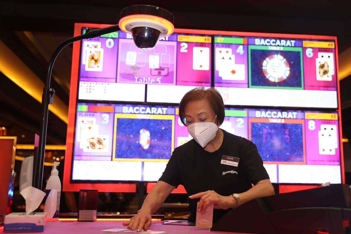 Table game dealer Annie Sit deals cards during a game of baccarat at Palace Station Casino in L ...