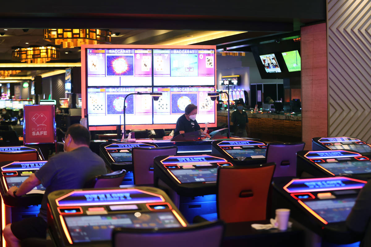 Table game dealer Annie Sit deals cards during a game of baccarat at Palace Station Casino in L ...