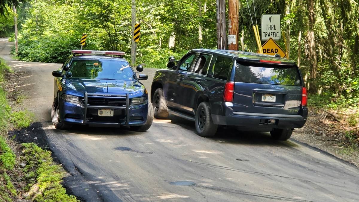 New York State Police block off a road near the scene where the body of Roy Den Hollander was f ...