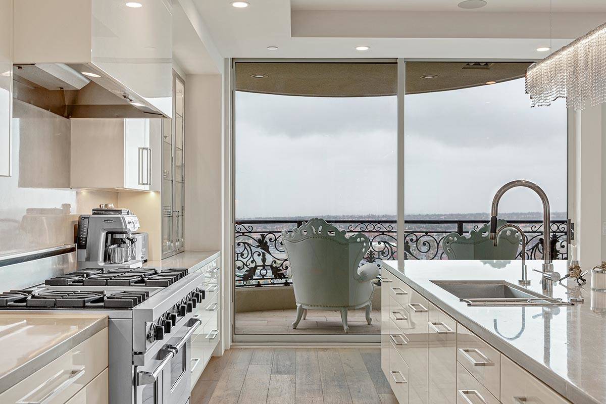 The kitchen in this One Queensridge Place penthouse opens to a balcony. (Luxe Estates & Lifestyles)
