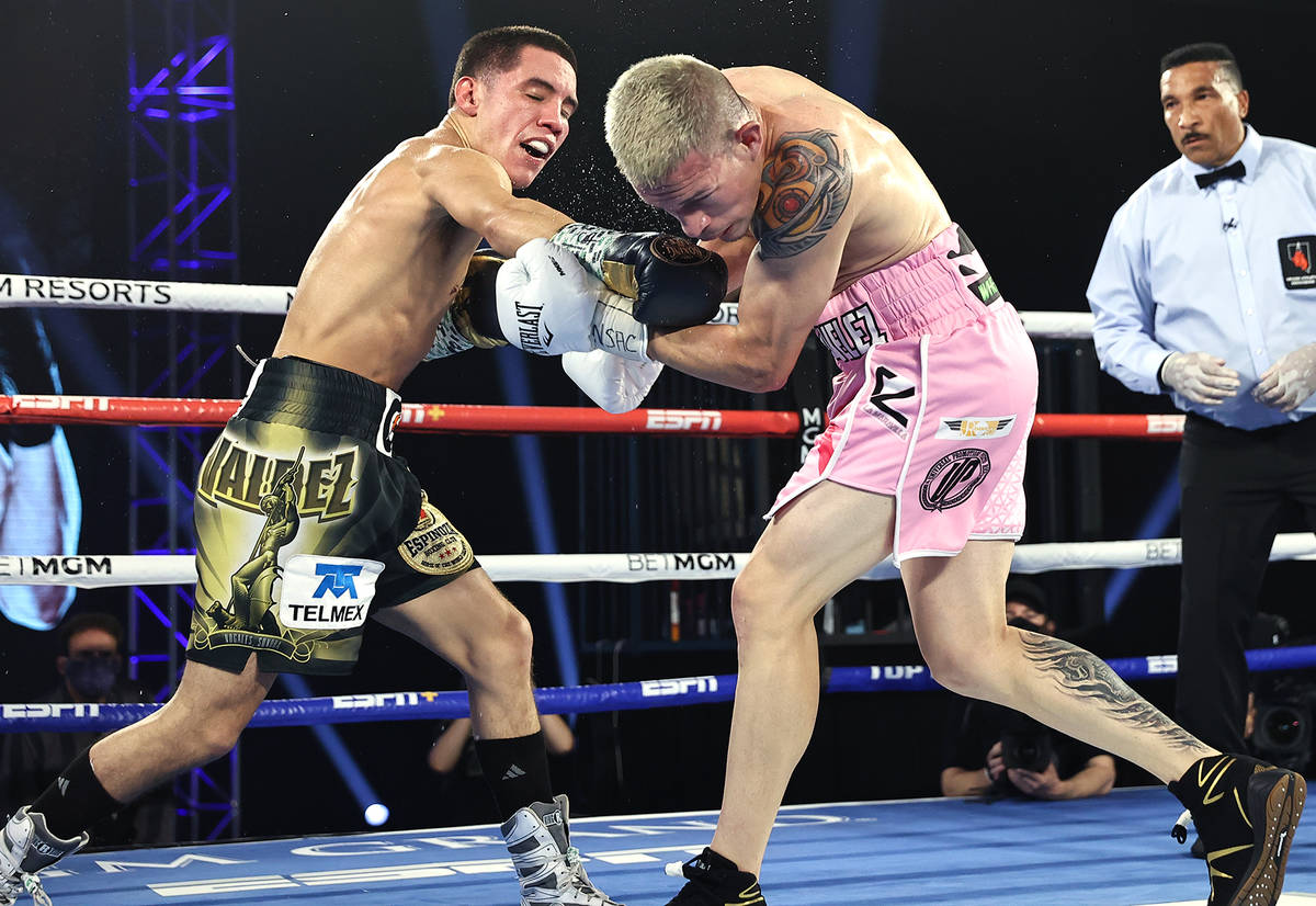 Oscar Valdez, left, connects with a punch against Jayson Velez during their junior lightweight ...