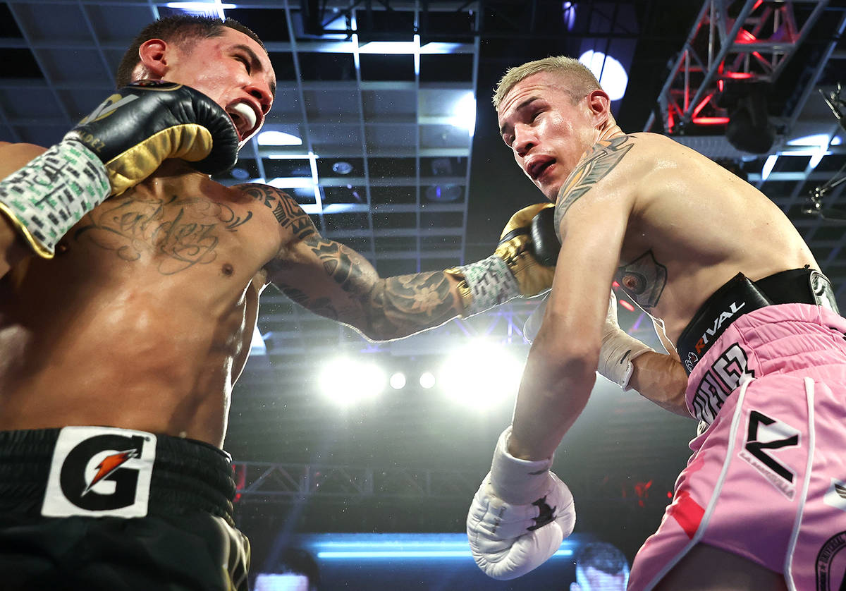 Oscar Valdez, left, connects with a punch against Jayson Velez during their junior lightweight ...