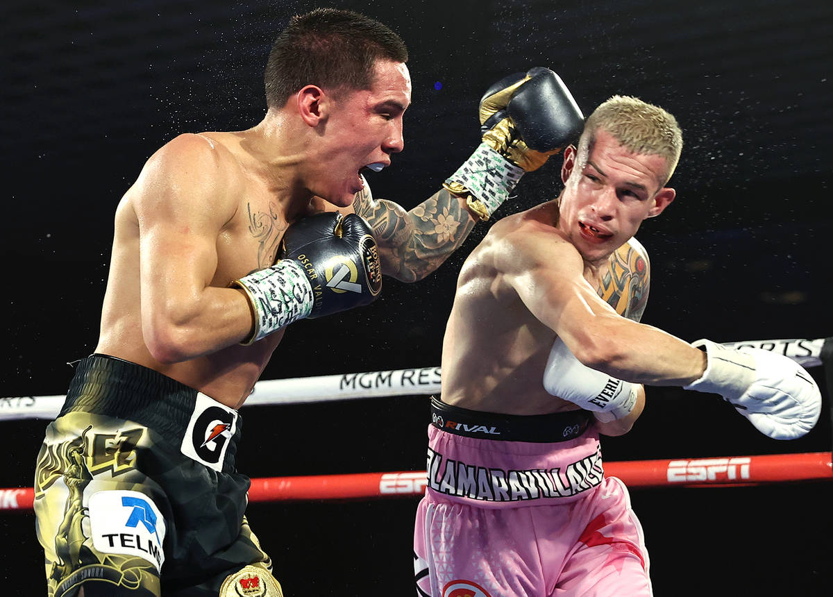Oscar Valdez, left, and Jayson Velez trade punches during their junior lightweight fight on Tue ...