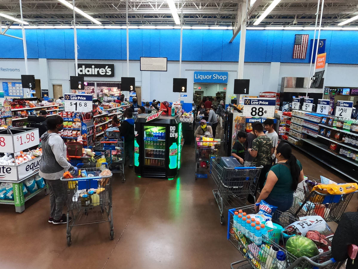 People line up to pay at the Walmart Supercenter in North Las Vegas on Saturday, April 4, 2020. ...