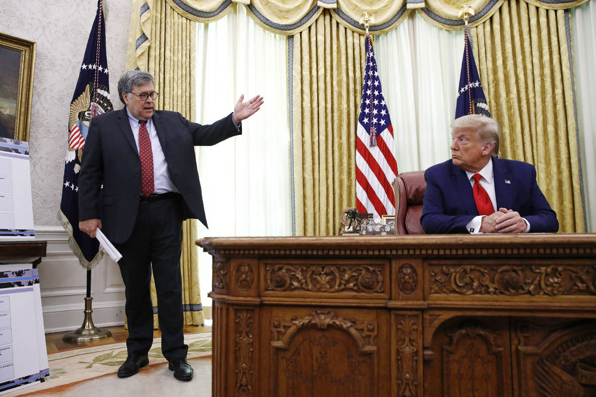 Attorney General William Barr, left, speaks with President Donald Trump during a a law enforcem ...