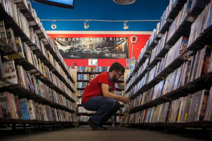 An employee works a movie section at a Vintage Stock store in Kansas City, Missouri. Vintage St ...
