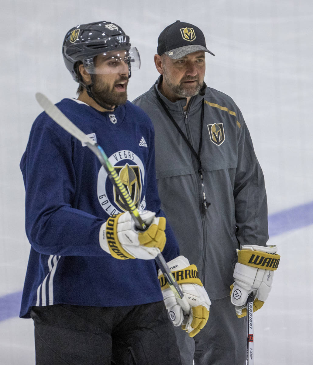 Vegas Golden Knights right wing Alex Tuch (89, left) chats with head coach Peter DeBoer during ...
