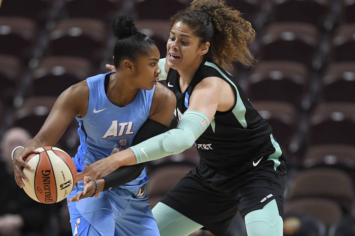 Atlanta Dream's Alex Bentley is pressured by New York Liberty's Amanda Zahui B. Of Sweden durin ...