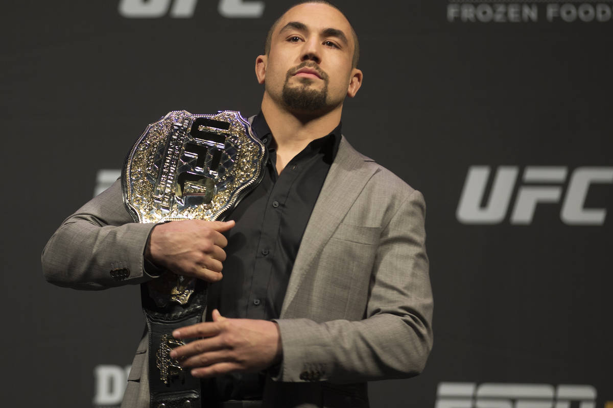UFC middleweight champion Robert Whittaker holds his belt during a press conference on Friday, ...