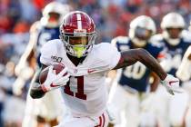 Alabama wide receiver Henry Ruggs III (11) caries the ball against Auburn during an NCAA colleg ...