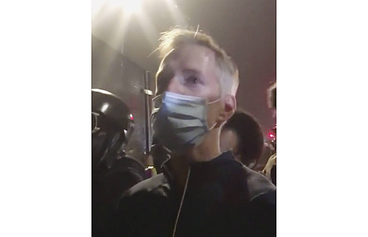 In this image made from video released by Karina Brown, Portland Mayor Ted Wheeler, stands at ...