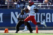 UNLV running back Charles Williams (8) runs for a touchdown against Northwestern during the fir ...
