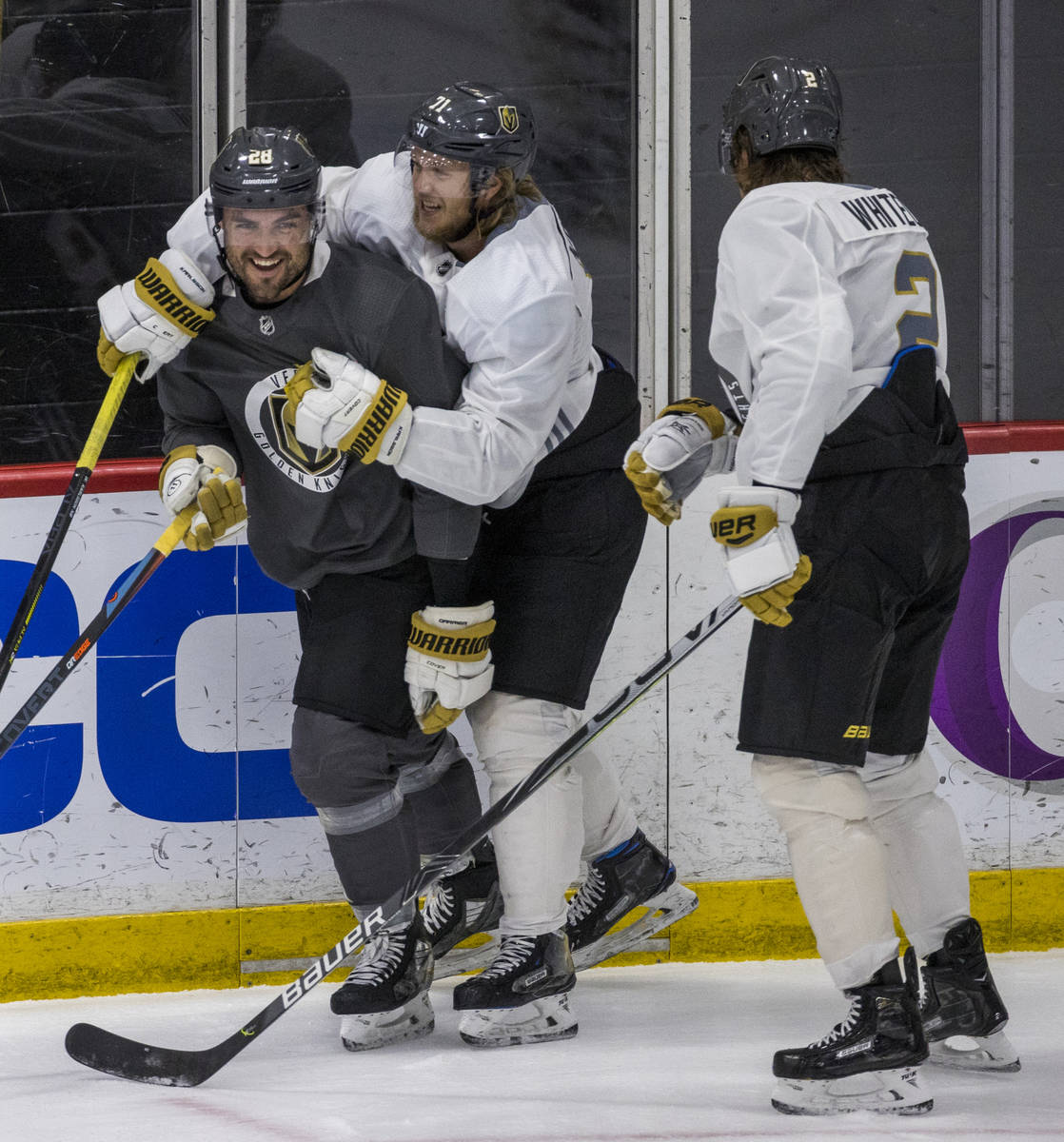 Vegas Golden Knights left wing William Carrier (28, left) is wrapped up by center William Karls ...
