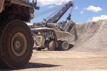A $30 million shovel at the Cortez Mine loads a bucket of dirt into a two-story tall dump truck ...