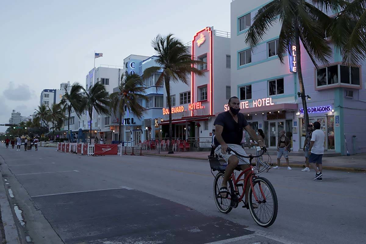 A sparse crowd is on Ocean Drive after an 8 p.m. curfew amid the coronavirus pandemic, Friday, ...