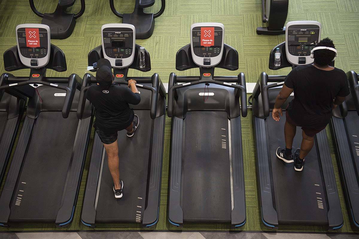 Gym members exercise between 'do not use' machines at PureGym in Leamington Spa, England, Satur ...