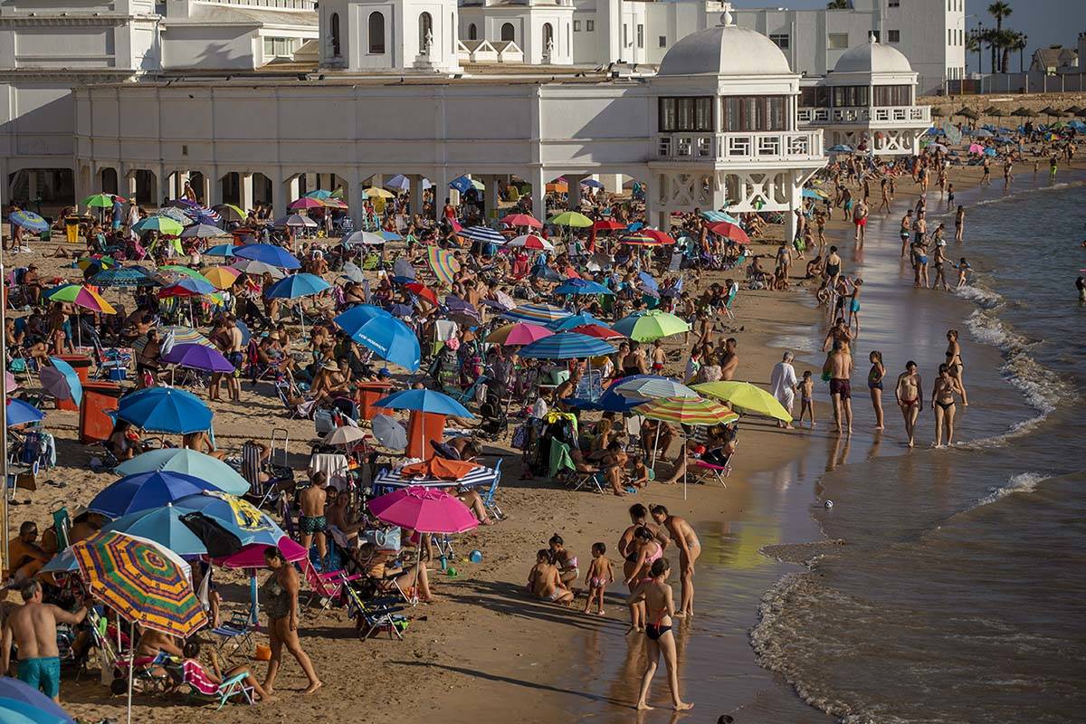 Bathers enjoy the beach in Cadiz, south of Spain, on Friday, July 24, 2020. With the coronaviru ...