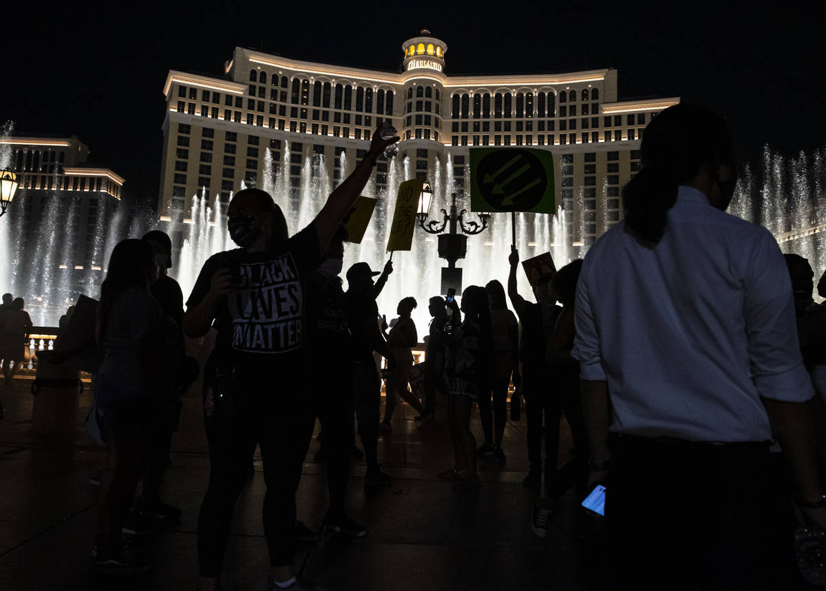 People gather by the Bellagio fountains at the end of a Black Lives Matter rally on the Las Veg ...