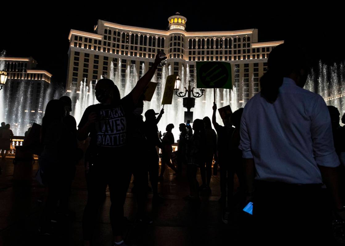People gather by the Bellagio fountains at the end of a Black Lives Matter rally on the Las Veg ...
