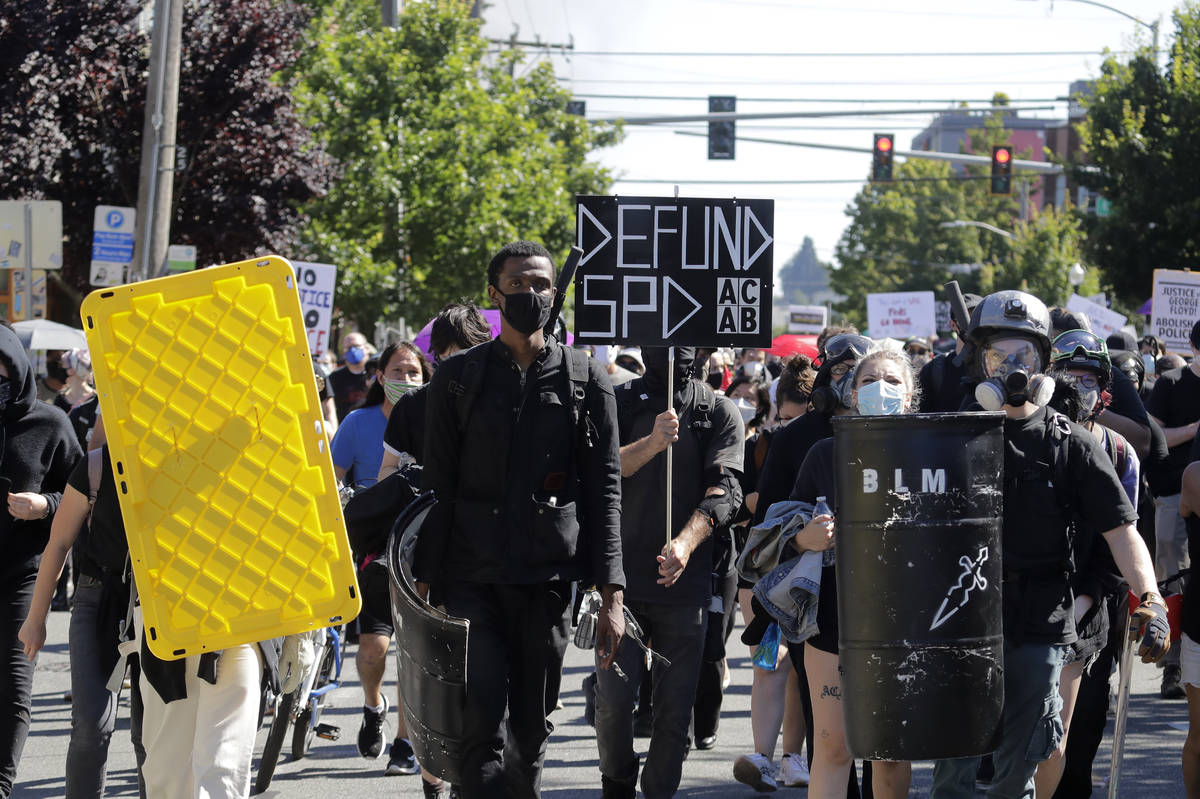 Protesters march near the King County Juvenile Detention Center, Saturday, July 25, 2020, in Se ...