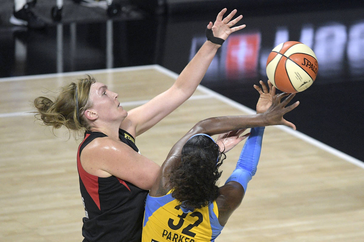 Chicago Sky forward Cheyenne Parker (32) is fouled by Las Vegas Sky center Carolyn Swords, left ...