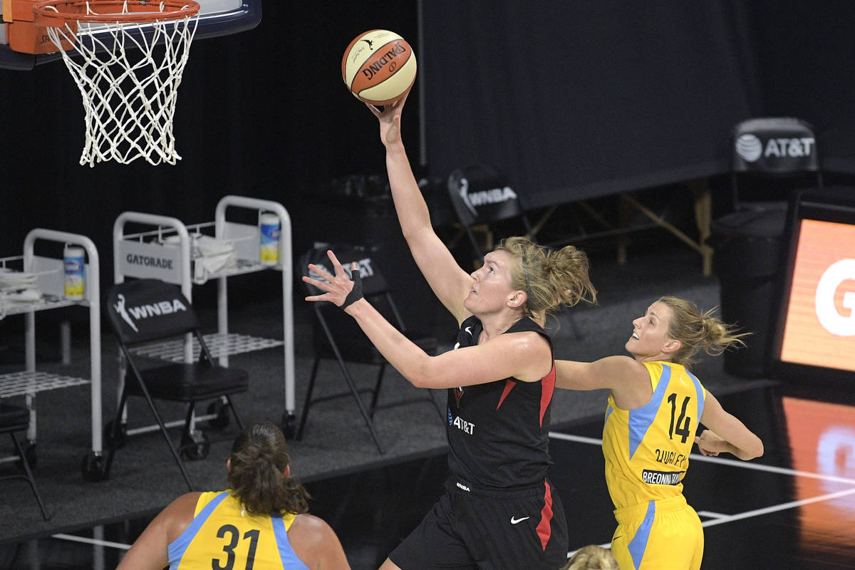 Las Vegas Aces center Carolyn Swords, center, goes up to shoot between Chicago Sky center Stefa ...