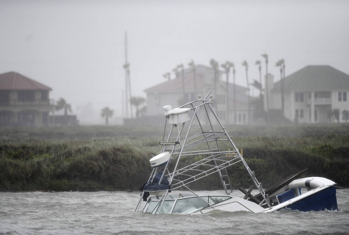 A boat sinks in the Packery Channel during Hurricane Hanna, Saturday, July 25, 2020, in North P ...