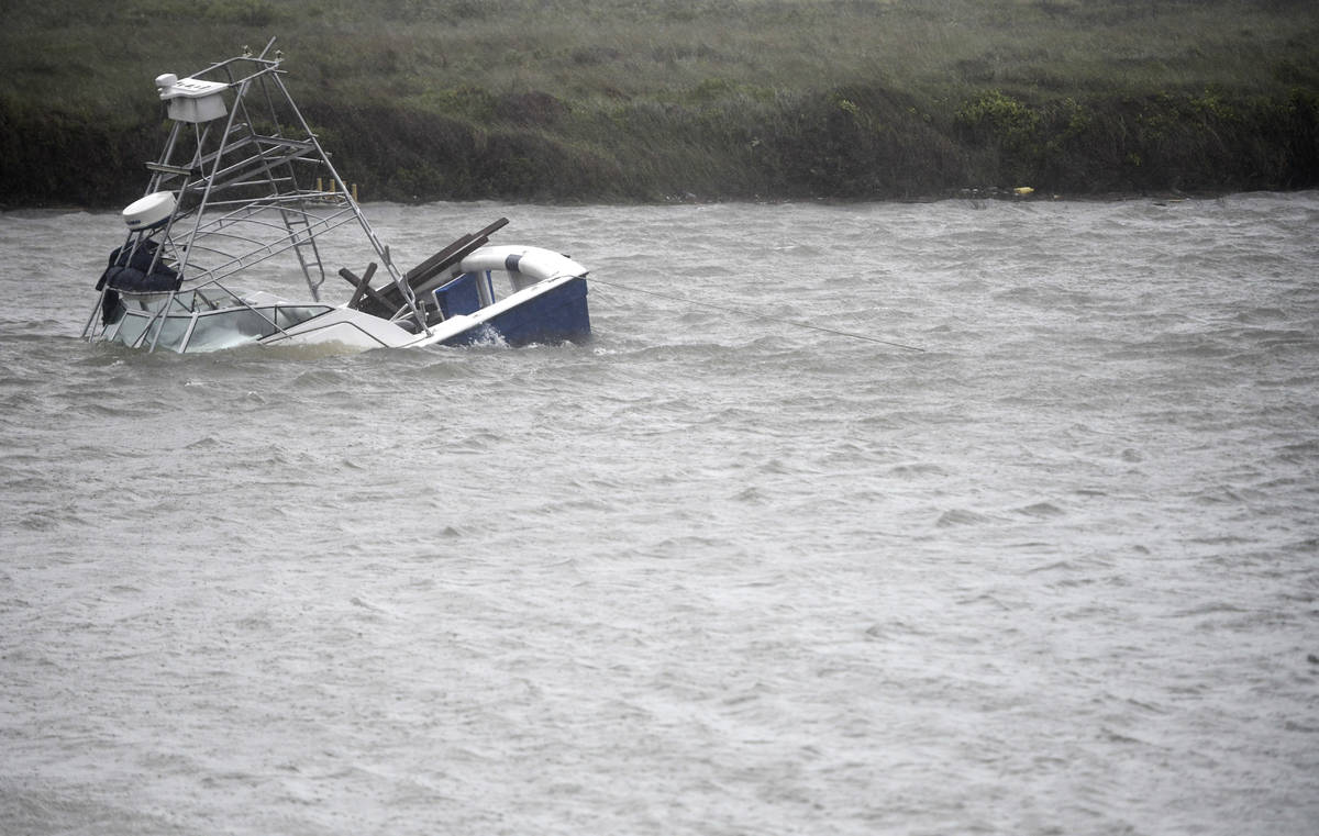 A boat sinks in the Packery Channel during Hurricane Hanna, Saturday, July 25, 2020, in North P ...