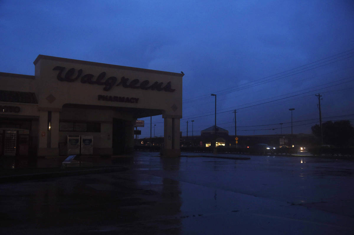 A darkened Walgreens is seen off of Saratoga and Staples during Hurricane Hanna, Saturday, July ...