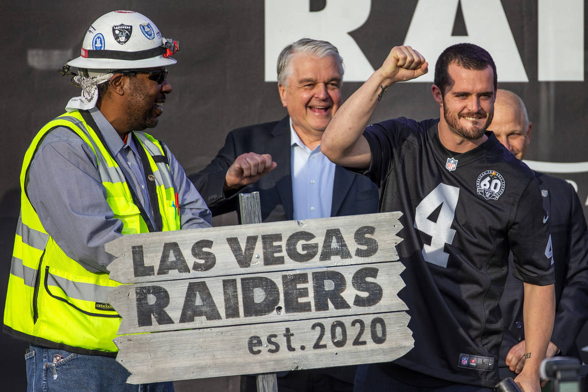 Las Vegas Raiders quarterback Derek Carr (4, center) pump a fist to the crowd after hammering a ...