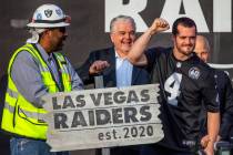 Las Vegas Raiders quarterback Derek Carr (4, center) pump a fist to the crowd after hammering a ...