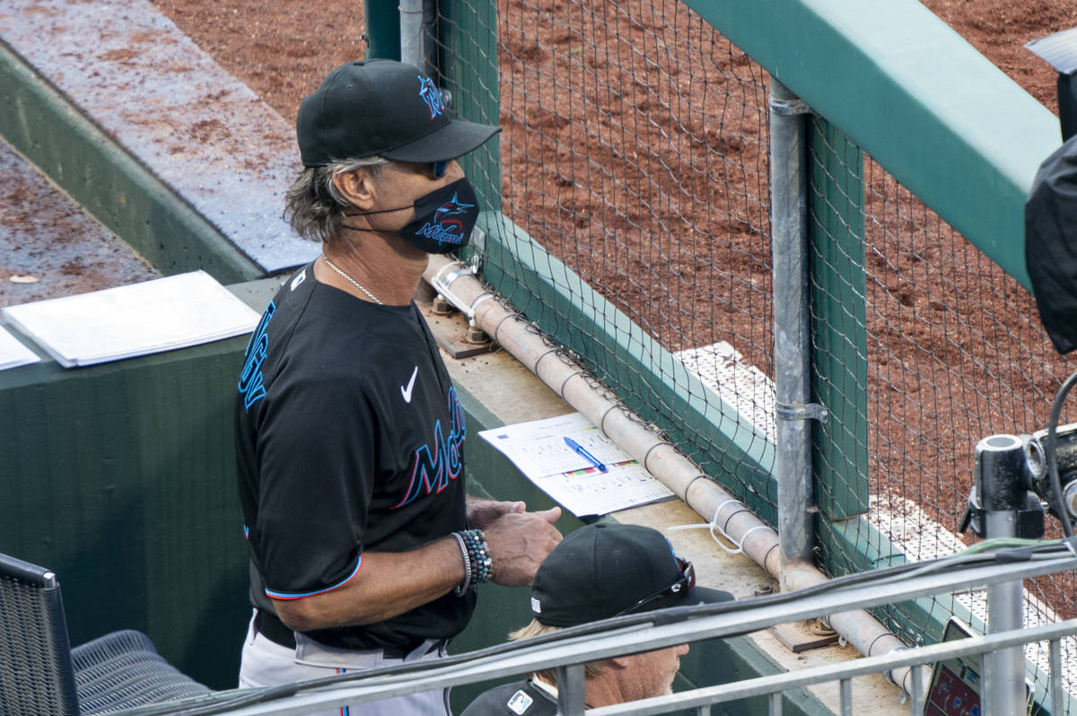 Miami Marlins' manager Don Mattingly looks out from the dugout during the eighth inning of a ba ...