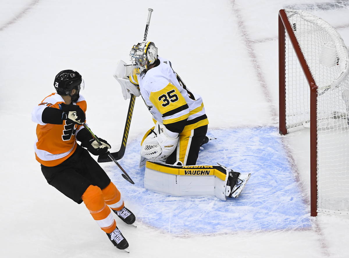 Philadelphia Flyers center Scott Laughton (21) scores the game winning goal against Pittsburgh ...