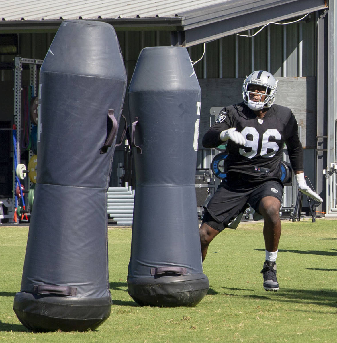 Oakland Raiders defensive end Clelin Ferrell (96) hits tackle posts during the NFL team's train ...