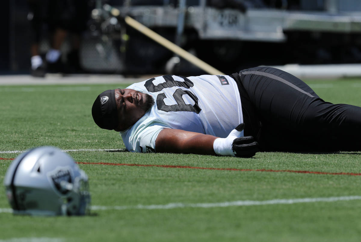 Oakland Raiders offensive guard Gabe Jackson (66) stretches during a mandatory mini-camp workou ...