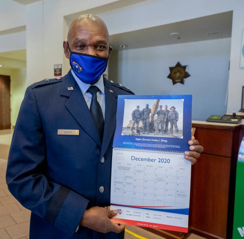 Maj. Gen. Ondra Berry holds a page in a calendar recognizing himself as Nevada's first African ...