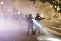 Federal officers deploy tear gas and crowd control munitions at demonstrators during a Black Li ...